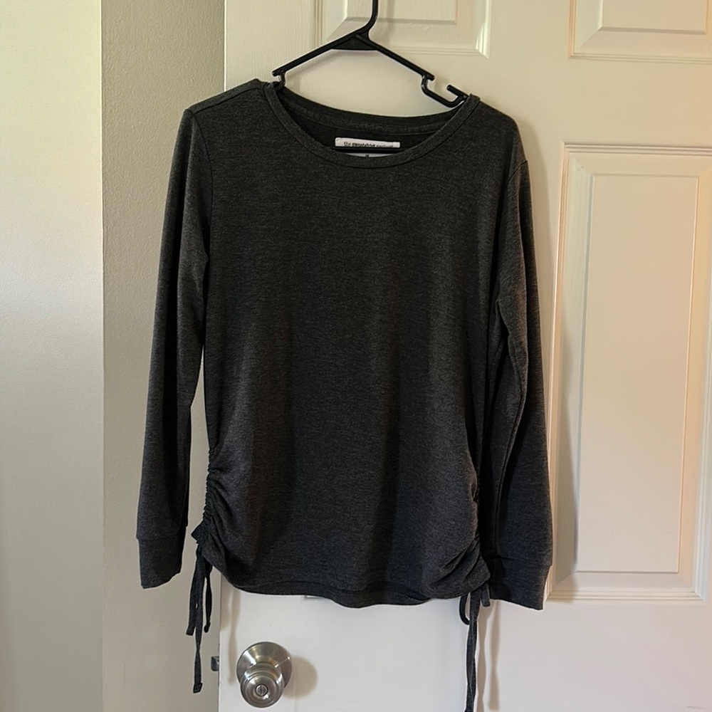 The sweatshirt project top with side ties. Dark gray in color and size medium.